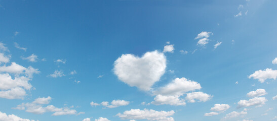 panoramic sky with flying clouds with heart shape. love romantic theme photo in high resolution