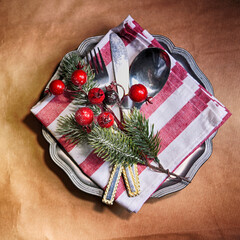 Christmas dinner background, plate and napkin on dark rustic table, top view