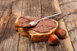 bread slice with chocolate spread on wood background