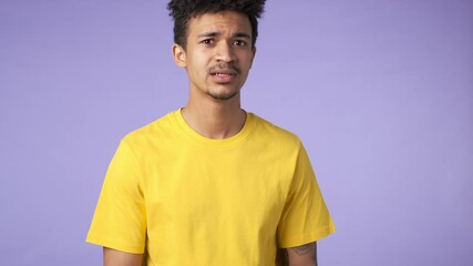 Poster - Young african emotional shocked guy isolated over purple background