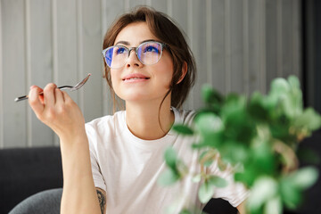 Sticker - Photo of happy woman smiling and looking aside while having breakfast