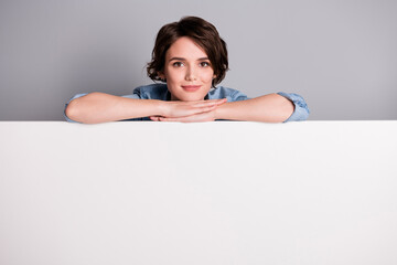 Poster - Portrait of confident cool girl promoter empty bill board close cover outfit present advert sales news isolated over gray color background