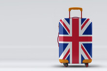 United Kingdom Flag On A Stylish Suitcases Back View On Color Background. Space For Text. International Travel And Tourism Concept. 3D Rendering.