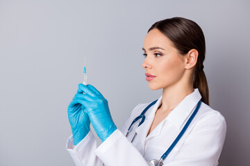 Poster - Closeup photo of professional doc serious nurse prepare syringe patient vaccination antibiotic wear latex gloves medical uniform lab coat stethoscope isolated grey background