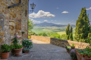 Poster - Sunny streets with colorful flowers with contrasting shades. Walk the Tuscan town