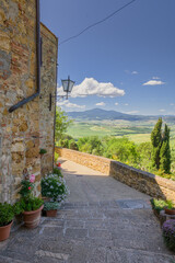 Poster - Sunny streets with colorful flowers with contrasting shades. Walk the Tuscan town