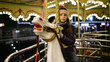© 4Max - Sad kid girl riding a carousel on a white horse at night
