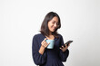 © halfbottle - Young Asian woman with mobile phone and coffee cup.