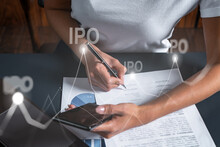 IPO Hologram And A Woman Signing Contract Use Phone. Double Exposure. Initial Primary Offering Concept.