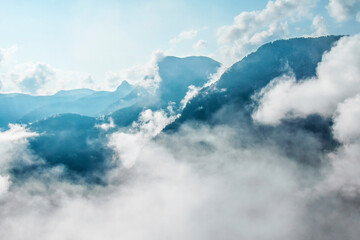 Wall Mural - photo of atmospheric blue misty mountains with clouds in the sky