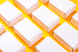 © mdbildes - Lot of square carton boxes on yellow background