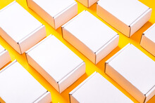 Lot Of Square Carton Boxes On Yellow Background
