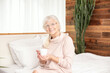 © neonshot - Happy smiling senior woman drinking coffee .