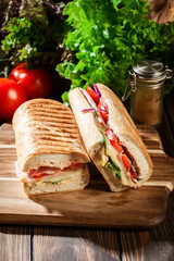 Wall Mural - Toasted panini with ham, cheese and arugula sandwich