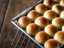 Small Dinner Bread Rolls In Baking Tin On Wooden Background