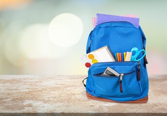 Poster - Classic school backpack with colorful school supplies and books on the desk.