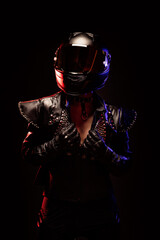 Wall Mural - Portrait of a young female biker wearing a studded leather jacket and a black helmet