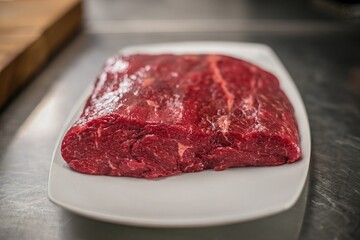 Wall Mural - Closeup shot of a raw beef piece on the table