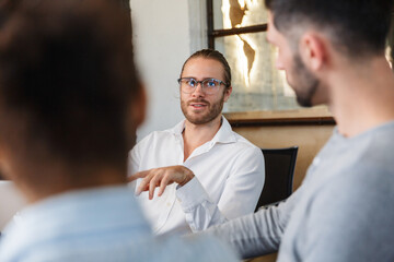 Wall Mural - Photo closeup of confident young discussing project while working