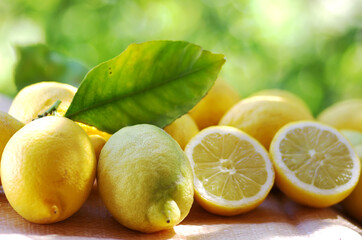 closeup of lemons on table, green background