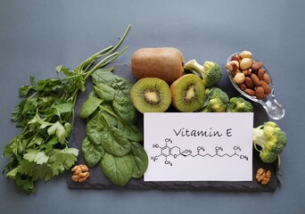 Wall Mural - Food rich in vitamin E with structural chemical formula of vitamin E molecule. Natural products containing vitamins, dietary fiber and minerals. Healthy sources of vitamin E, healthy diet food.