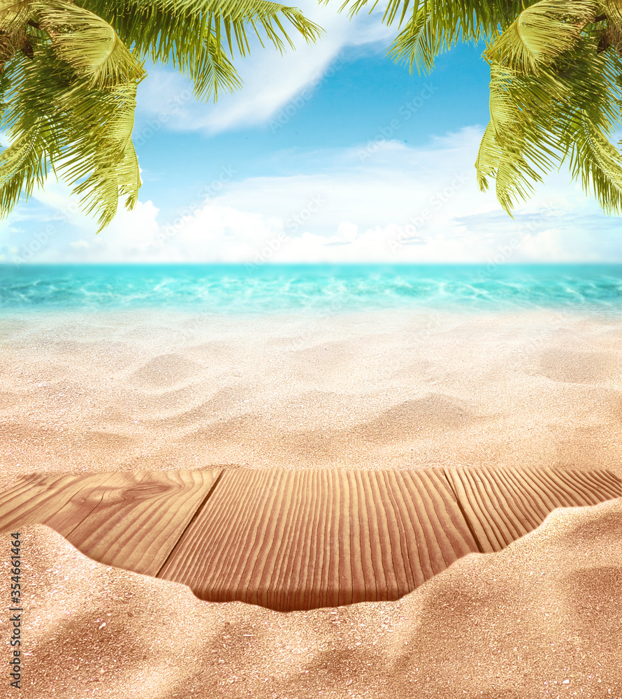 Tropical fine sandy beach with blured sea sun sky clouds background with wooden table top and empty space for product advertisement Montage of summer relaxation background - obrazy, fototapety, plakaty 