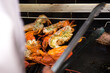Chef grilling lobster on barbeque oven