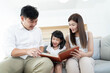 © sattahipbeach - Asian family happy love to reading favorite book together, parents teach kids self learning at home in hobby time
