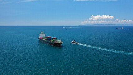 Aerial drone photo of fully loaded container cargo ship cruising in open ocean deep blue sea