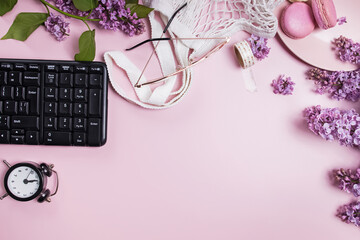 Spring flat lay with lilac flowers, glasses and macarons