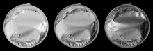 Shiny Round Piece Of Plastic Foil Trash Or Garbage Isolated On Black Under Different Light Settings, Silver Chips Packaging Cap.