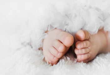 Baby feet on a lace skirt