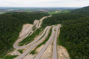 Aerial top vew of winding road in the mountains, drone shot. Altai Krai, Western Siberia, Russia. Road to Resort town Belokurikha 2