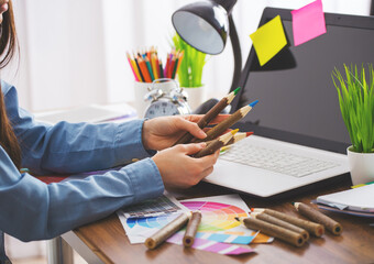 designer drawing something with a color pencils in a modern office