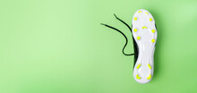 Close-up Of The Sole Of Football Boots With Thorns On Green Background. Football Theme Background. Long Banner.