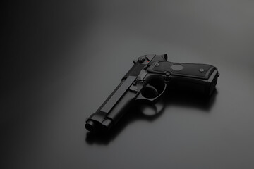 Wall Mural - Modern black gun on a dark background. Pistol