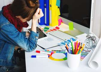 Wall Mural - young woman artist drawing something on graphic tablet at the office