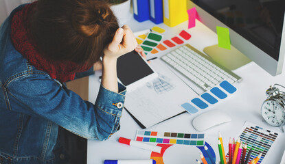 Wall Mural - young woman artist drawing something on graphic tablet at the office