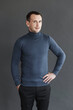 © Vladimir - man in a blue sweater on a gray background