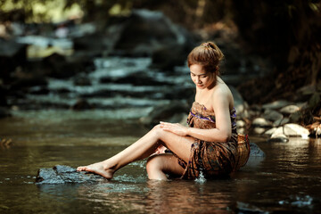 Asian sexy woman washing in streams The girl was bathing in the brook, woman washing in the stream, country girl portrait in outdoors.