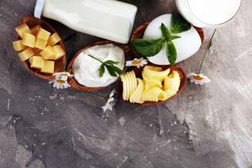 Wall Mural - milk products. tasty healthy dairy products on a table on. mozzarella in a bowl, cottage cheese bowl, butter swirls, glass bottle