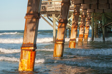Florida Wooden Pier Posts With Waves And Dramatic Lighting
