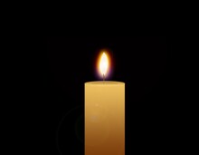 Flaming Candle Isolated On A Black Background