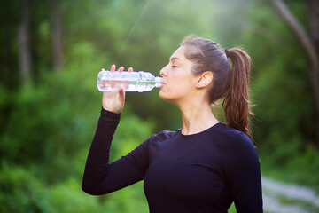 Active sport woman drinking water