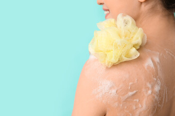 Wall Mural - Beautiful young woman taking shower on color background