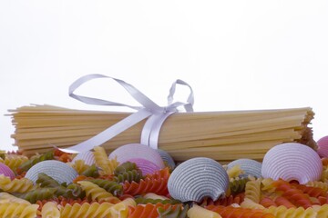 Poster - Closeup shot of delicious colorful organic Italian pasta and spaghetti on a white background