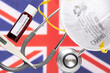 Concept of Coronavirus or Covid-19 pandemic to use as background with UK England British country flag and medical blood test, stethoscope, surgical N95 mask, thermometer