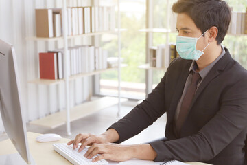 Business people or office worker are working and wear mask for protect Covid-19 or corona virus disease but business must be continuous, healthcare concept 