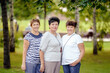 © lialia699 - Mature Female Friends Socializing In Backyard Together.
