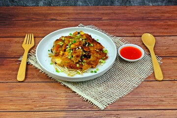 Crispy fried mussels pancake on wooden table.